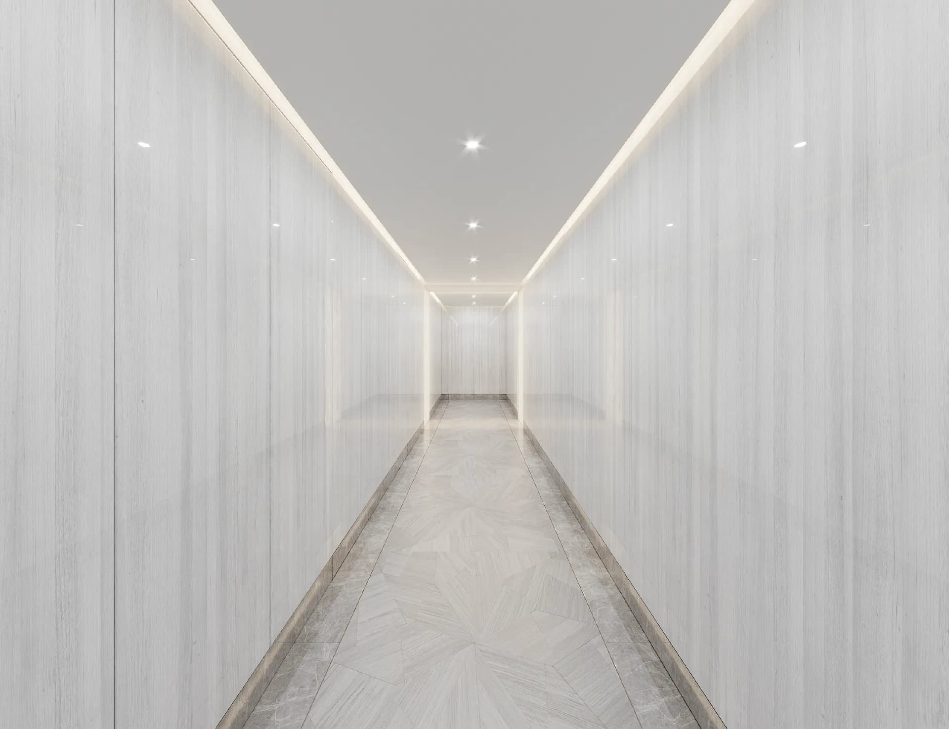 Long stone-clad corridor with cove lighting — Villa Nudra, Saadiyat Island